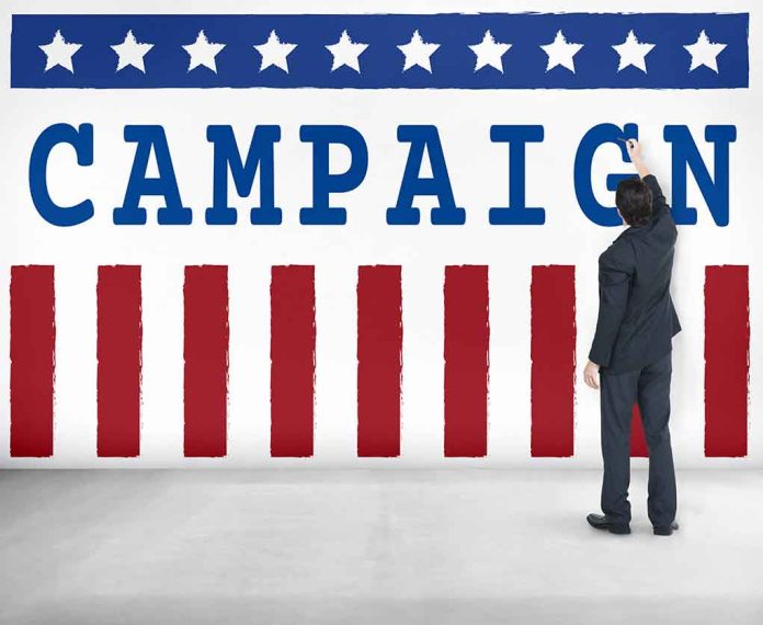 Man pointing at "CAMPAIGN" sign with stars and stripes.