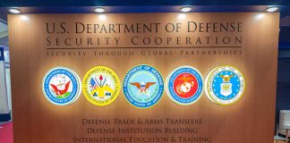 U.S. Department of Defense Security Cooperation display with logos.