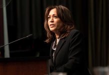 Person speaking at a podium with microphone.