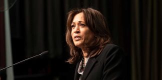 Person speaking at a podium with microphone.