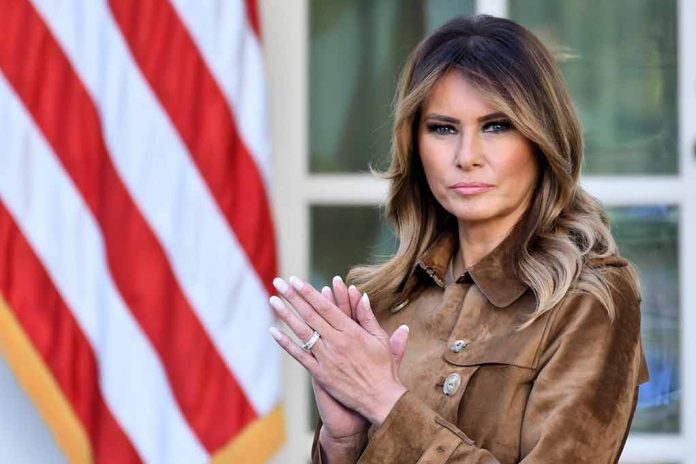 Woman standing near American flag, clapping her hands.