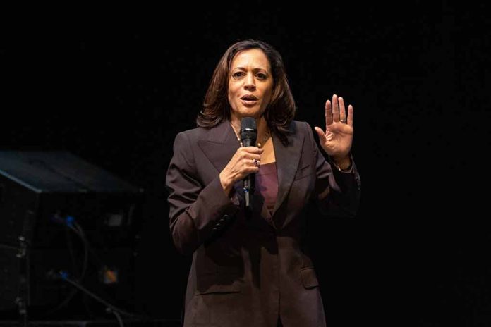 Person speaking on stage, holding a microphone.