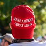 Red "Make America Great Again" hat on person's head.