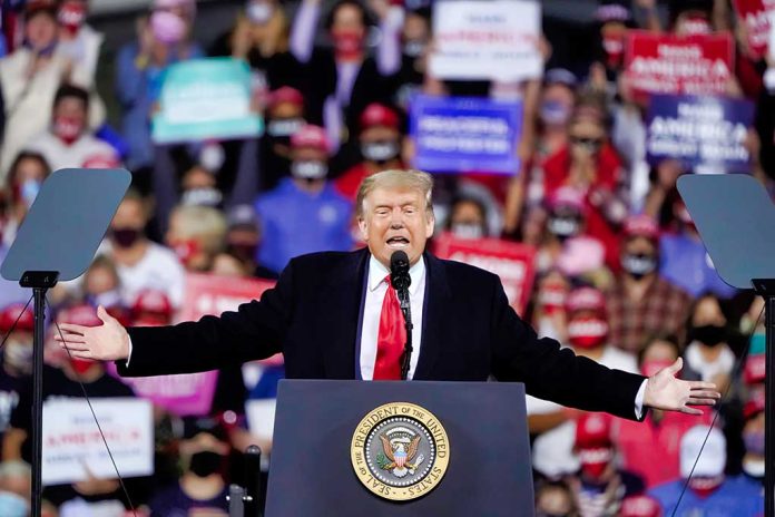 Person speaking at a podium during a rally.