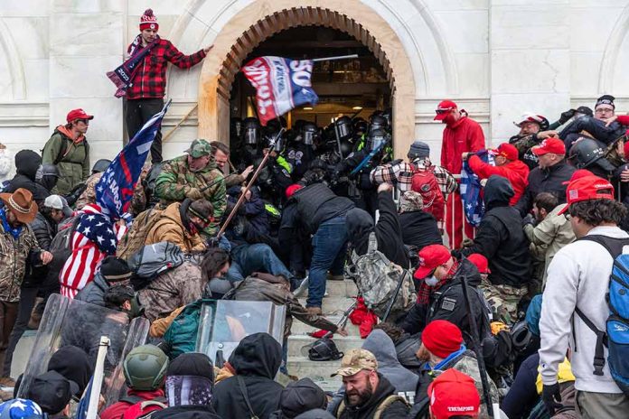 Crowd storming a building entrance with flags and signs.