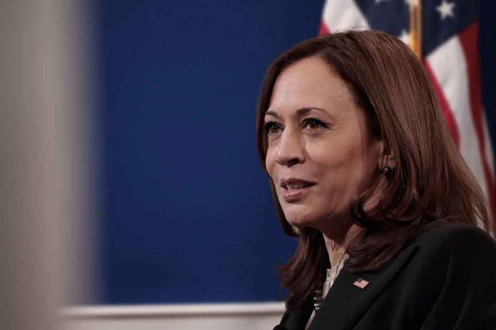 A woman speaking with an American flag in background.