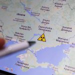 Map of Ukraine with a radiation warning symbol.