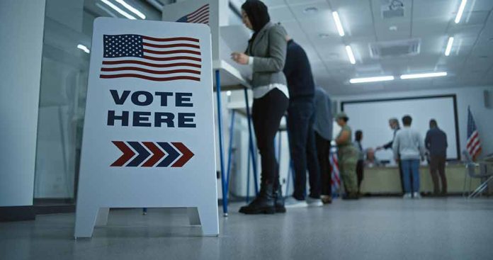 Sign reading "Vote Here" in a polling station.