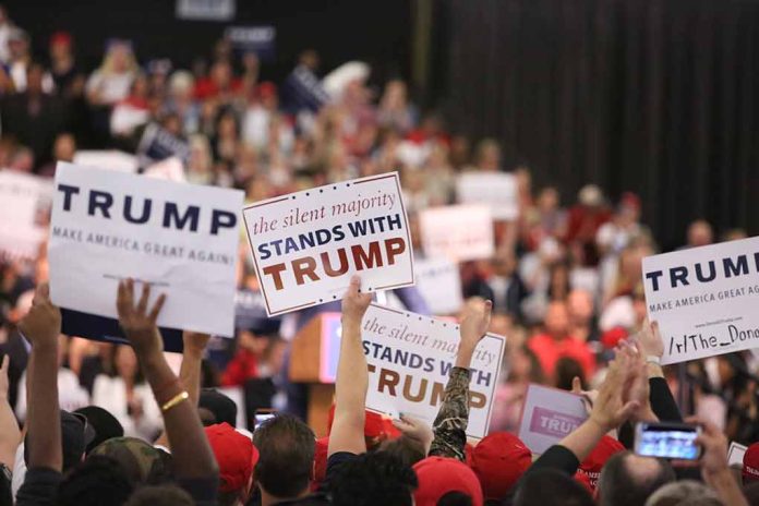 Crowd holding signs supporting Trump at a rally.