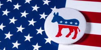 Democratic donkey button on American flag background.