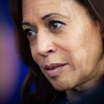 Woman with brown hair and thoughtful expression.