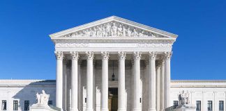 United States Supreme Court building under clear blue sky.