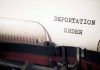 Typewriter with "Deportation Order" typed on paper.