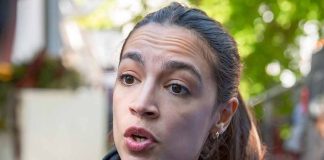 Woman speaking with a concerned expression outdoors.