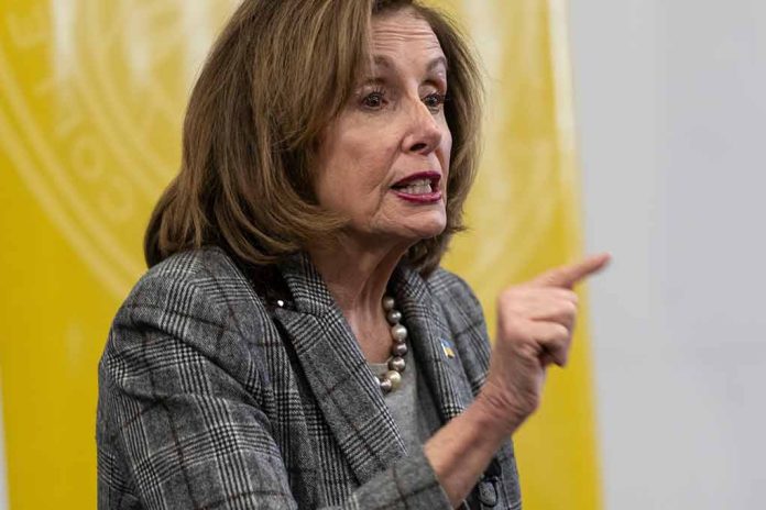 Woman speaking and pointing, wearing a plaid jacket.