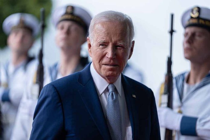 Man in suit with military personnel in background.