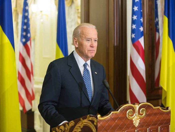 Man speaking at podium with flags in background.