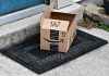 Open Amazon package on doorstep doormat.