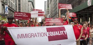 Group holding "IMMIGRATION EQUALITY" banner at a parade.