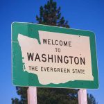 Welcome to Washington state sign under blue sky.