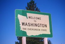 Welcome to Washington state sign under blue sky.