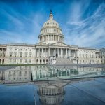 U.S. Capitol Building under a vibrant blue sky.