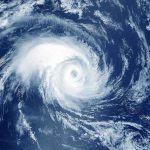 Satellite image of a swirling hurricane over ocean.