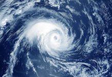 Satellite image of a swirling hurricane over ocean.