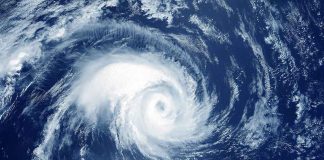 Satellite image of a swirling hurricane over ocean.