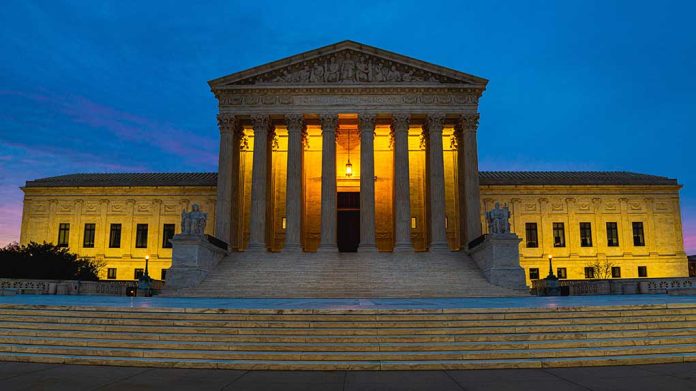 Illuminated courthouse building at dusk with columns