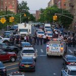 Police activity on a city street with emergency vehicles.