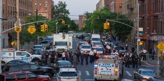 Police activity on a city street with emergency vehicles.