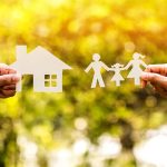 Paper cutouts of a house and family outdoors.