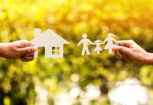 Paper cutouts of a house and family outdoors.