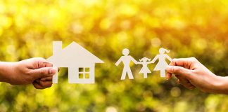 Paper cutouts of a house and family outdoors.