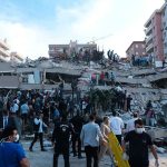 People at a collapsed building after an earthquake.