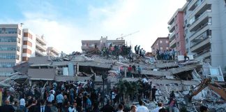 People at a collapsed building after an earthquake.