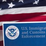 US flag with Immigration and Customs Enforcement sign