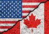 USA and Canada flags with a crack dividing them