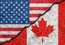 USA and Canada flags with a crack dividing them