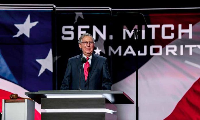 Man speaking at podium with American flag backdrop.