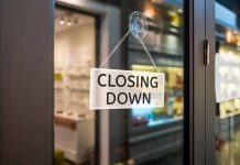 "Closing Down" sign on a shop door.