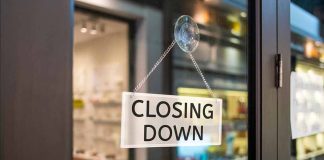 "Closing Down" sign on a shop door.