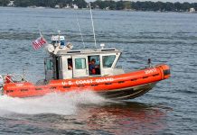 U.S. Coast Guard boat speeding on water.