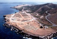 Buildings and roads near the ocean on hilly terrain