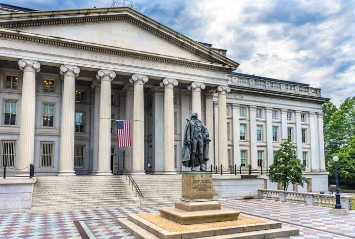 Government building with statue and American flag outside.