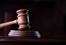 Wooden gavel on a dark background.
