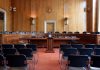 Empty courtroom with chairs and wooden walls