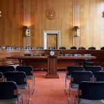Empty courtroom with chairs and wooden walls
