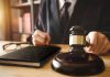 Person in suit with gavel at desk